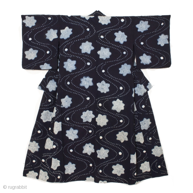 This is a Japanese indigo dyed cotton shibori kimono. A combination of shibori dying techniques are used to achieve this beautiful stream and maple leaf motif. The meandering stream pattern is made  ...