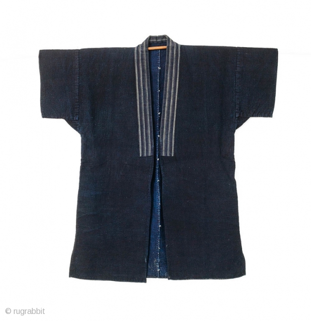 This is a Japanese sashiko noragi, or quilted coat, from Shonai, Yamagata prefecture of Japan. 

This jacket's entire surface is dyed with a deep natural indigo and is densely sashiko stitched. The  ...