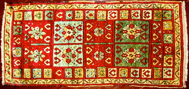 Eastern Anatolian Yastik with a deep pile, wonderfully vibrant colors and Gelveri motifs in field and border, 19th century. Very fine condition. 17'' x 41'' (43 x 104cm)     
