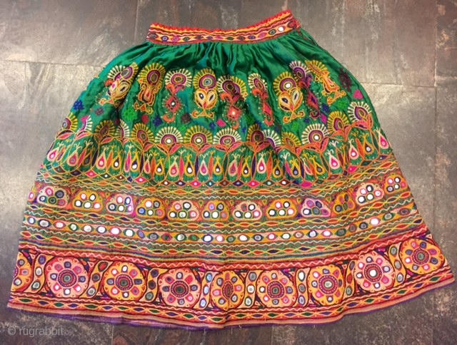 kutchi rabari child skirt hand embroided on satin silk from makhana village in kutch region gujarat the skirt is having beautiful hand embroided design of peacocks and flowers with beautiful base of  ...