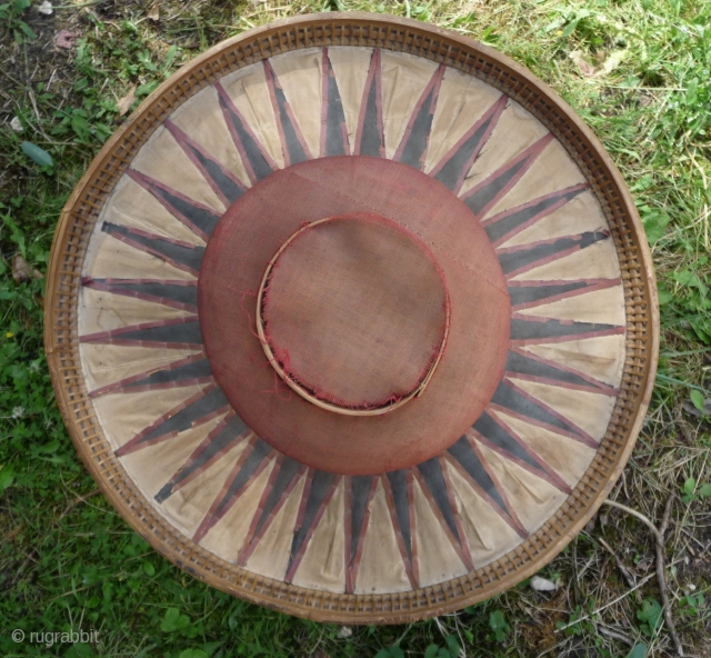 this is a beautiful and rare antique indonesian hat from the south sulawesi. it is made of palm leaves, decorated with pieced cloth and embroidery.the round base is perhaps bambu. please note  ...