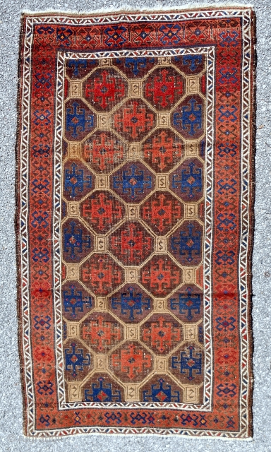 1870-80 Baluch. Uncommon Baluch rug with a distinctive Memling gul lattice. Turkish knotted. Splendid color with true camel. Good condition. All original. 
          
