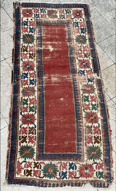 Early Kazak red field complete rug. Circa 1820. About 4 x 9 ft. Clean. Excellent saturated color including a clear, old purple. All original. Decent condition for age. Much better than most. ...
