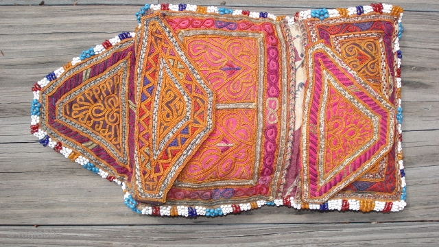 Afghan Embroidered Purse:  
Several intricate embroidery techniques. 
Metallic threads in the couching embroidery. 
Multi-color seed beads surround. 
Circa 1920s. 
Attributed to the Hazara ethnic group. 
Size: 7 inches fully open by  ...