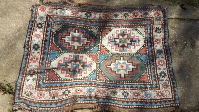 Kazak fragment with Memling guls. As found, dirty, moth-eaten and miserable. Seems to be a cut and shut piece of a larger rug. Thick loose weave and floppy handle.

Fabulous colours though.

120cm x  ...