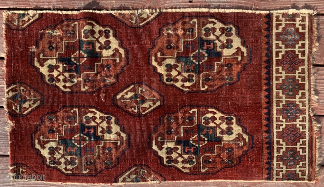 Early  possibly 18th century, S Group main Salor carpet fragment.
In addition to early border drawing, the piece has a lovely
violet patina and unusual drawing for a main carpet.

Dimensions: 35" X 20"  ...