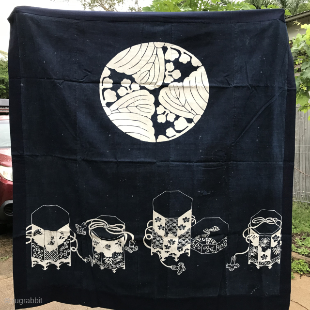 Japanese indigo “tsutsugaki” futon cover, hand loomed cotton, probably early 20th century, 146 cm wide x 156 cm long, family crest (mon) and containers for the shell matching game, “kaiawase”; some repairs ...