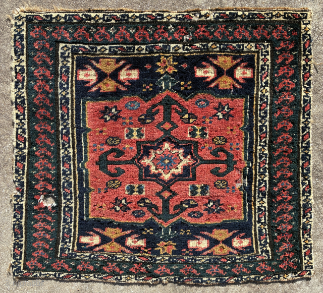 Enigmatic NW Persian pile khorjin face, 62 x 58, petrol green ground in the chicken border, ground of the centre panel is deep indigo, wool warps, cotton wefts, condition issues such as  ...