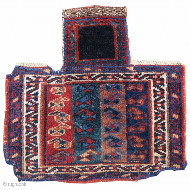 This small pile Afshar salt bag draws bands of paisleys against a ground of four different colored stripes. A white vine-scroll border frames the bottom portion of the piece, while a solitary  ...