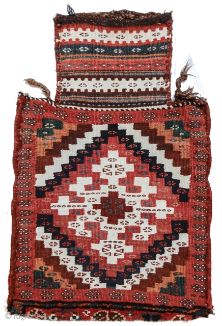 This Luri-Bakhtiari ( or possibly Veramin ) salt bag is a graphic delight. A central cruciform element is drawn in white cotton against a deep rose madder ground, surrounded by diagonally radiating  ...