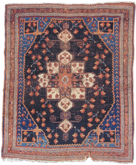 Afshar tribal weavers were inspired both by luxurious silk and woolen textiles as well as by formal city carpets from the urban weaving centers of Persia. This small rug has a medallion  ...