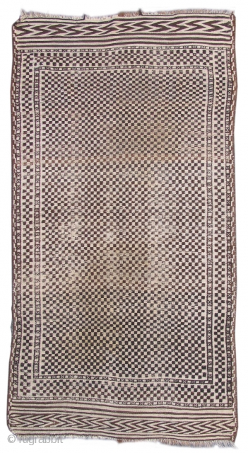 Afghan? Tribal Rug, Using un-dyed wool this rug weaves a graphically intriguing checker-board design. worn but very chic. 
size is 3'6"x6'7" 
inv #17293
Early 20th Century        
