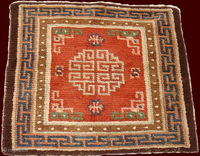 Tibetan Square Mat with an uncommon red ground and light blue medallion. Nice use of greens and undyed brown, 19th century (4th quarter) , 2'x 2'2"
inv # 7015_S
     