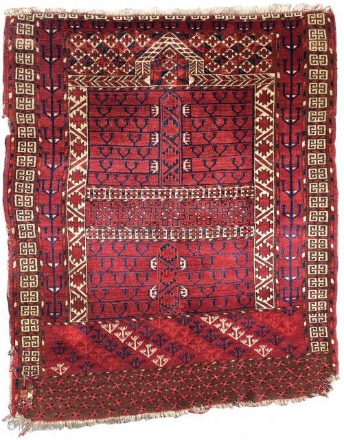 Tekke ensi, early 19th Century, This ensi belongs to a distinct subset of Tekke Turkmen examples to use open-spaced side panels with abstract tress composed of pairs of linked ram heads. Two  ...