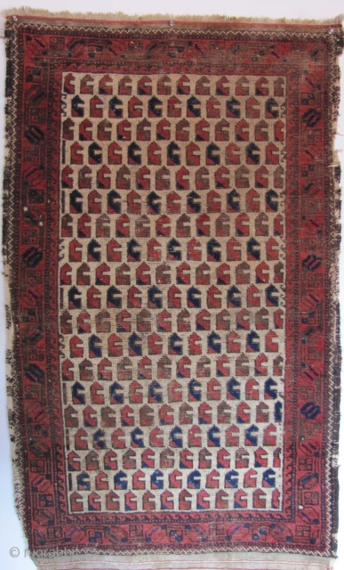 
A quirky Baluch with extremely rare "monkey wrench" design (or are they animal heads? or chess pieces?). Open right on a handspun-cotton foundation. 19th century. 140x87cms       