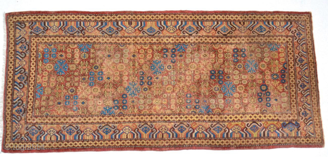 A Late 18th Century Herati Pattern Khotan rug. Khotan Carpet East Turkestan, circa 1900 The terracotta field with a lattice of flowering angular vines enclosed by borders of hooked and scrolled devices  ...