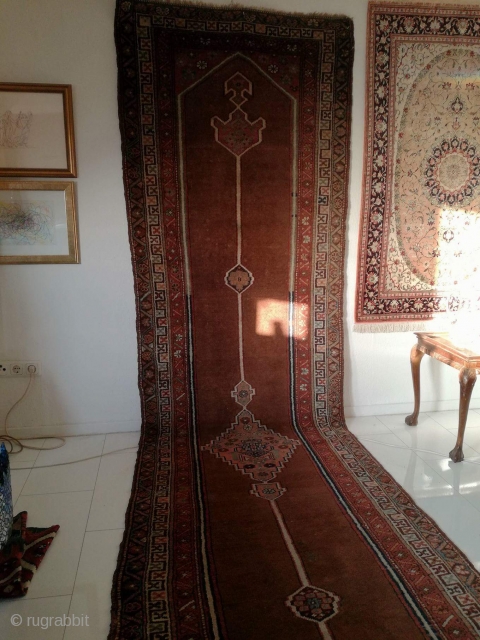 An antique camel hair ground NW Persian runner with 430/108 cm in good condition. Two spots repiled. One side with kilim ending, the other open. On wool rug.     