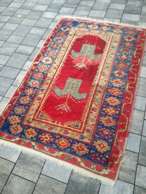 An antique Anatolian rug with 170/110 cm. Repiles and demages. Rare design.                     