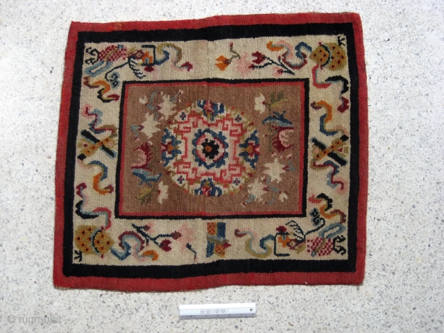 Tibetan seating carpet,featuring auspicious symbols,-in overall excellent condition.-Est.early 20th century.                       