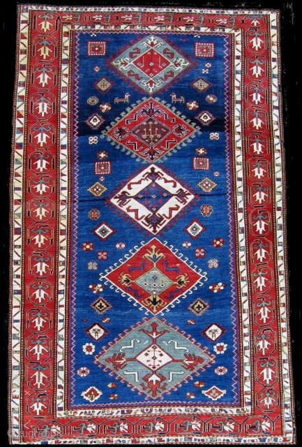An elegant blue field Kazak rug with a particularly appealing border design.  Circa 1850, 5'1" x 8'4" 
              