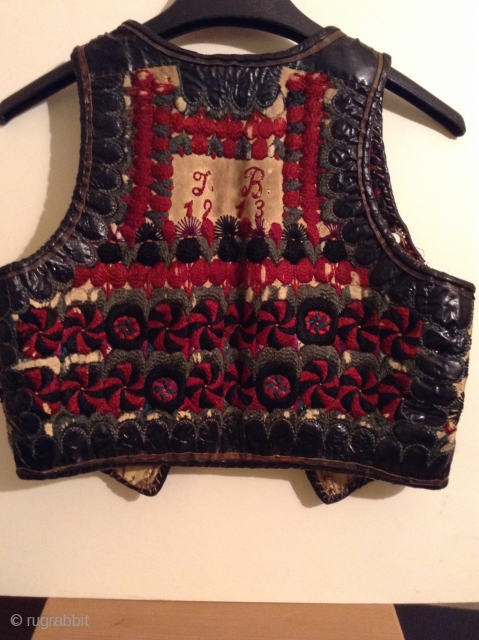 I believe this is an Hungarian or Transylvanian vest, but I am not positive.  It is embroidered on leather and  still has some of the fur lining.
There are slight damages  ...