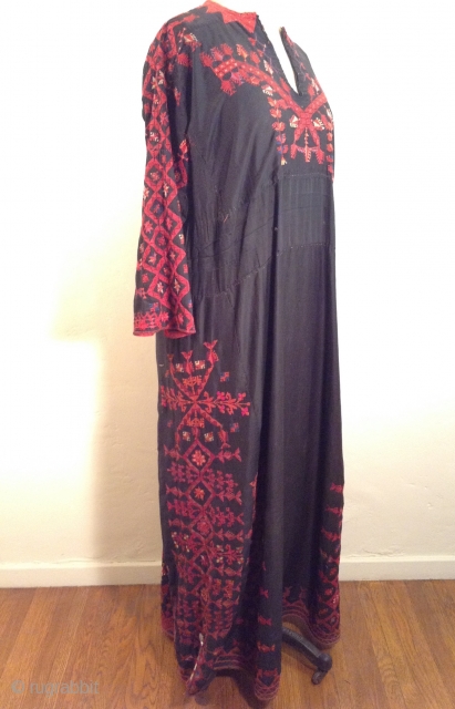 This is a beautiful Palestinian embroidered dress. it has a signature at the bottom and it is in perfect condition. i tried to highlight a photo of the embroidered signature plus a  ...