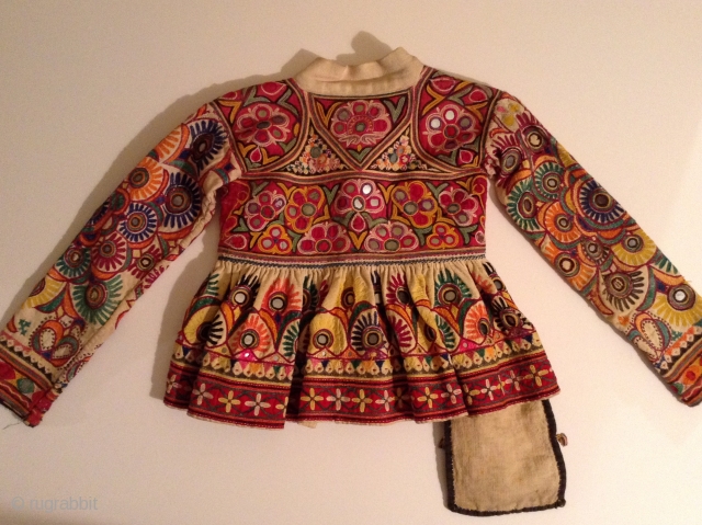 This is a child's dress from Gujarat, India.  It is a wrap around dress that looks to be about a size 3 to 5.  It is in very good condition  ...