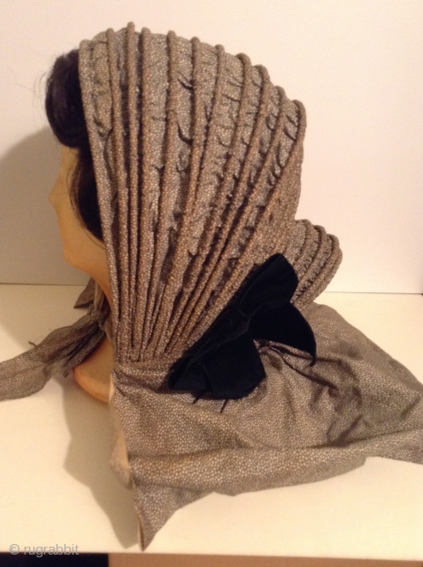 This is a rare Pilgram's Bonnet from the early 19th century.  It has metal stays between the inner and outer fabric that allow the wearer to flatten the bonnet for storage  ...