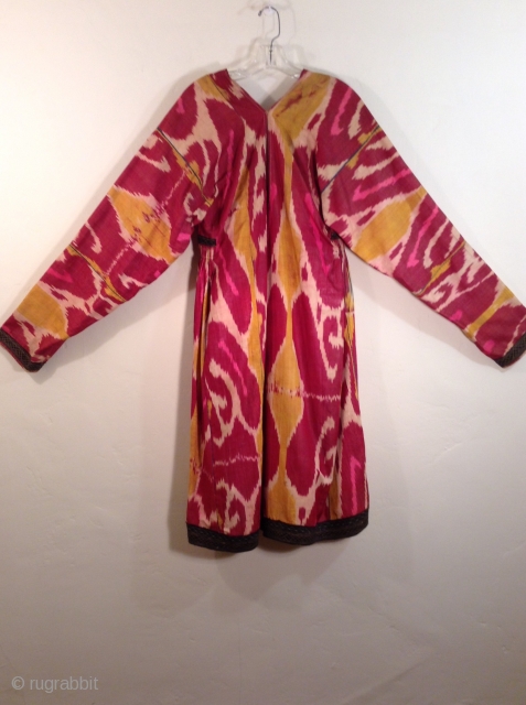This is an Uzbek ikat silk dress with very traditional colors.  It is in very good condition and would fit a large woman.         
