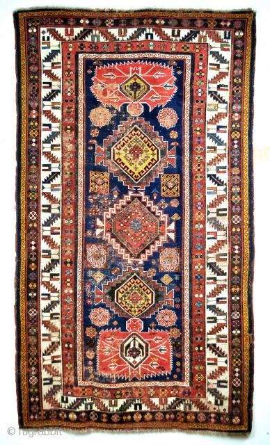 Iconic Shirvan, late 19th century. Mazdaism all over, the red medaillons are the winged God Farouvar of Mazda protecting the rug. 
In the border on the white ground vure and fire toartch.  ...