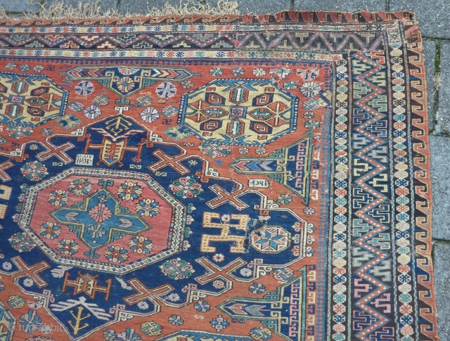 Dated Kuba Sumakh 1877 ( 1294 ), 280 x 198 cm., 9' 2" x  6' 6". With patches, damages and lots of joyfully used faded early fuchsine dye.    