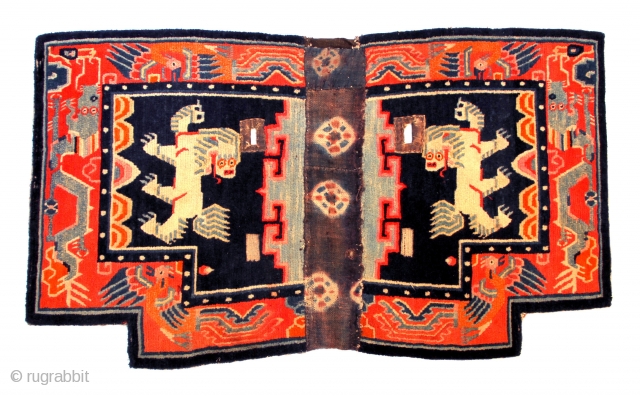 TIBETAN SADDLE CARPET  TC06

Horse Carpet with Snow Lion design
43 3/4” w x  25” h

Used but good solid condition.  Early ~ mid 20th c.

Got this in Tibet around 20 years  ...