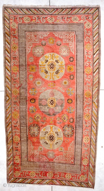 #6724 Antique Khotan Rug
This Circa 1880 Khotan/ Yarkand measures 4’9” x 9’0”. It has a fantastic bittersweet field with three round medallions in very pale green and aubergine with touches of yellow  ...