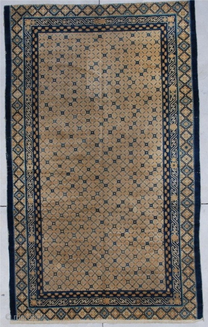 #6882 Very Antique Kansu Chinese Rug 
This circa 1800 or earlier  Chinese rug measures 5’7” x 9’2”. It has a yellow ground with the crosshatch design in a flower motif.   ...