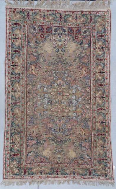 This mid 19th-century Turkish Kayseri silk and metal rug measures 4’4” x 6’10”. It has a center medallion with a double Kum Kopu prayer niche at either end completely covered in a  ...
