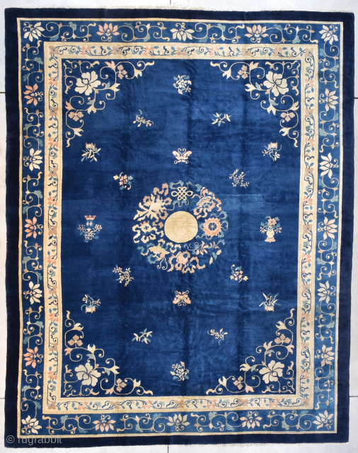 This circa 1900 Peking Chinese antique Oriental Rug measures 9’3” X 11’8” (283 x 359 cm). It has a dark blue field with a center medallion composed of Shou symbol (long life) ...