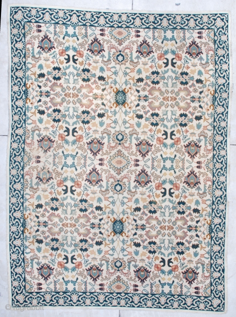 This semi-antique Portuguese Chain Stitch rug measures 8’0” x 11’0”. It has an overall design with palmettes in blue, green, and rust with vines and flowers on an ivory ground.  The  ...