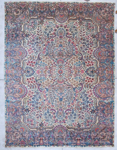 
#6970 Antique Laver Kerman Rug 
This circa 1920 Laver Kerman Persian Oriental rug measures 8’9” X 11’7”.  It has a very busy over all design with a small medallion which practically  ...