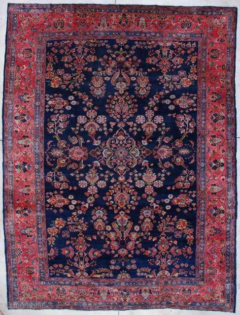 #7050 Mahajaran Sarouk Antique Persian Rug This circa 1910 Mahajaran Sarouk antique Persian Oriental Rug measures 9’1″ X 11’10”. It has the so-called empty design motif with a floral medallion.  It  ...