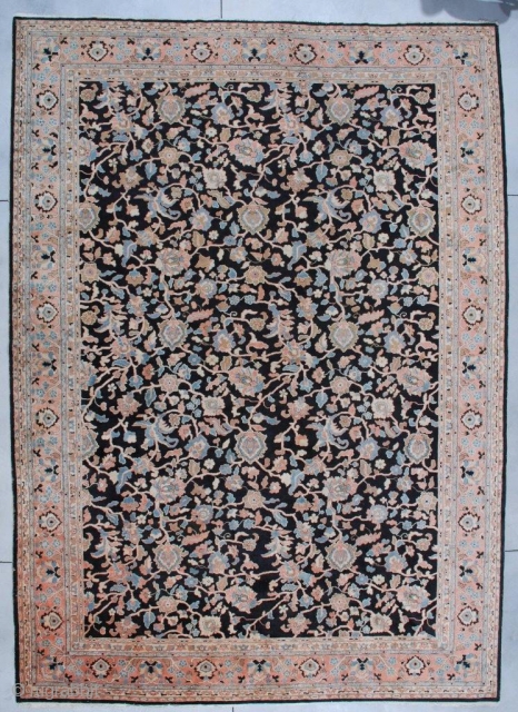 #7116 Antique Agra Rug from India. This Agra measures 11’1” x 15’3”. It has a black background with a vine and tendril design in   coral, very pale sky blue, ivory  ...