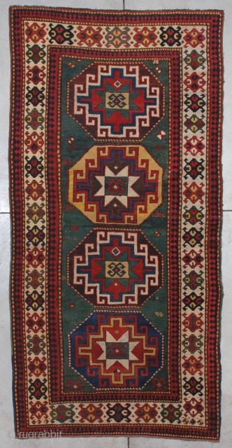 #7198 Kazak Antique Caucasian Rug 
This third-quarter 19th-century Kazak measures 4’2” X 8’5” (128 x 259cm). It has four memling gul medallions, one on a blue ground, one on an aubergine ground,  ...