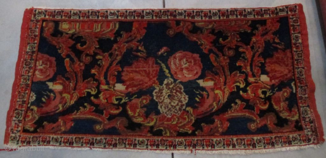 This circa 1910 Senna Sampler #8156 measures 1’9” X 3’6”. It has roses on a dark blue ground in various shades of red, pink,and ivory. It has very decorative vine work in  ...
