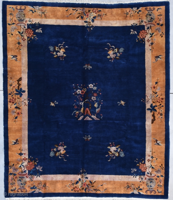 This circa 1920 Art Deco Chinese #7931
 rug measures 8’2” x 9’6”. It has a deep indigo field containing floral sprays in each quarter and one in each quadrant of the field.  ...