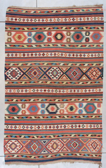 This early to mid-19th century Caucasian (Shirvan) Kilim #7489 measures 5’11” x 9’6” (179 x 292 cm). It is a beautifully drawn Caucasian kilim in striped motif with Memling guls, diamonds, triangles,  ...