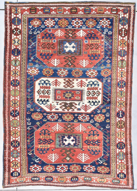 This circa 1880 Kazak #8104 measures 5’9” X 8’5”. It is a fantastic Kazak with a motif of three 8 sided medallions. The medallion in the center is ivory and is flanked  ...