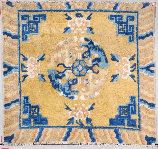 #7286 Antique Ningxia Mat This circa 1860 Ningxia meditation mat measures 2’0” x 2’1” (60 x 64cm). It has a mustard ground with Chinese fretwork in blue in the corners. The border  ...