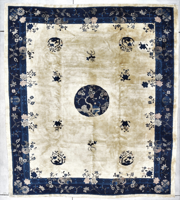 This late 19th century Peking Chinese Oriental rug #7896 measures 8’7” X 9’6”. It has four rondels containing and antlered animal under a tree and six flower sprays in two shades of  ...