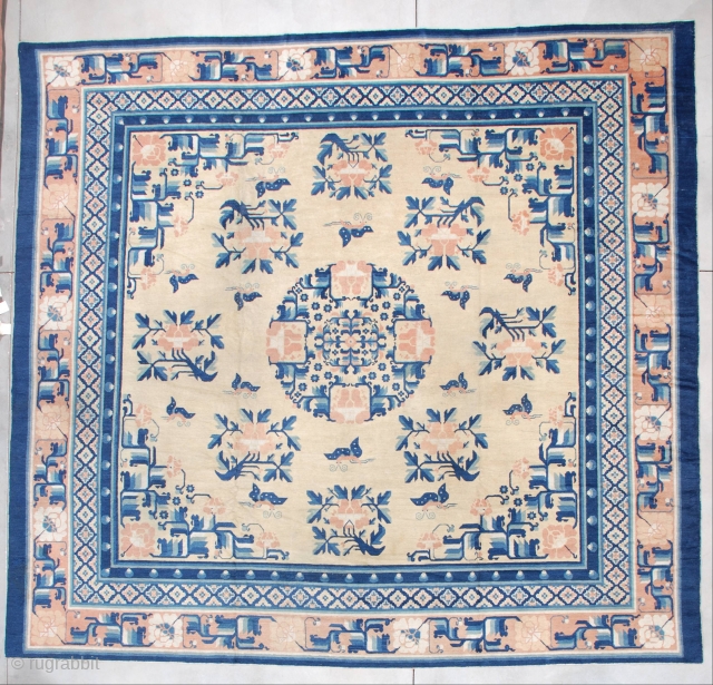 This pre 1850’s Ningxia Chinese rug measures a nearly square 12’3’ x 11’9” (374.9 x 362.71 cm). The field is the color of unsalted butter. It has a medallion composed of lotus  ...