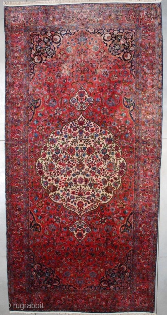  This circa 1920 antique Kashan Persian Oriental carpet measures 9’6” X 19’10” (292 x 609). This carpet of unbelievable quality is woven with Manchester wool. It has a large pulled medallion  ...