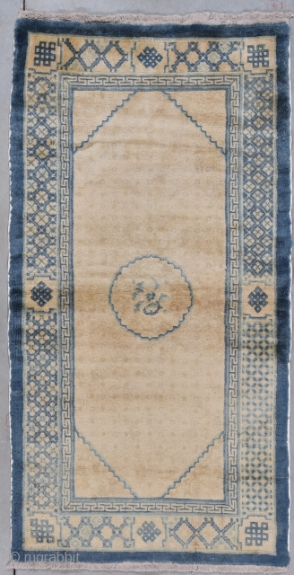 This circa 1930 Peking Chinese Oriental Rug measures 3’1” X 5’10”. It has an ivory ground geometric center medallion in blue on an ivory ground with a deep and almost invisible design  ...